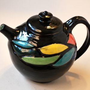 Carved and Painted Teapot with Black Background